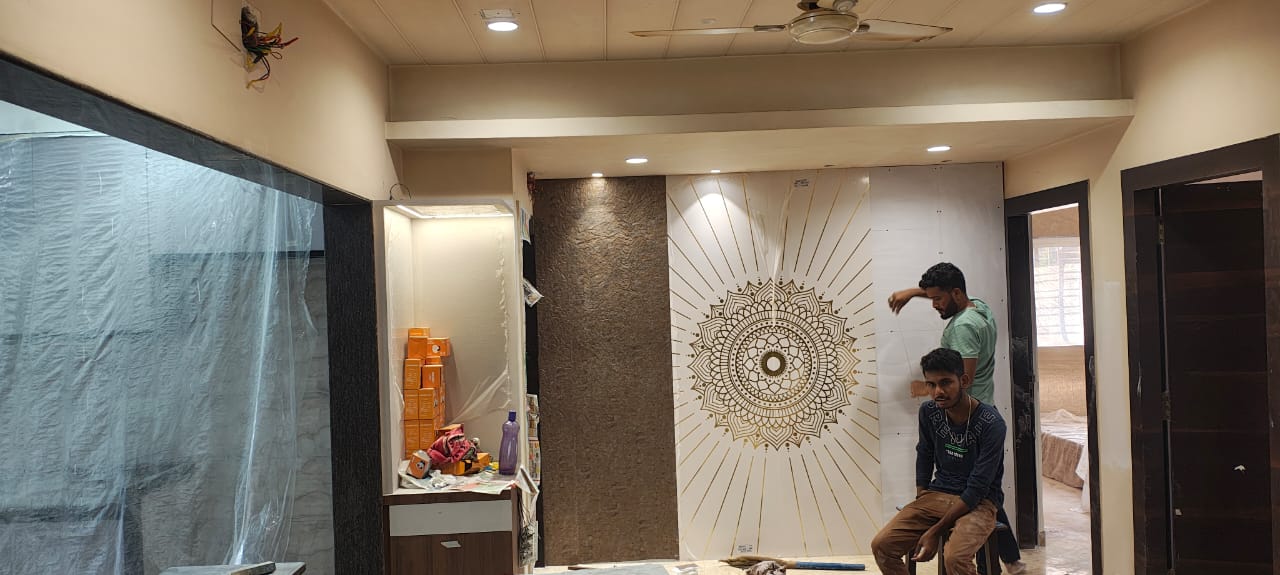 Craftsmen actively installing a feature mandala panel on site