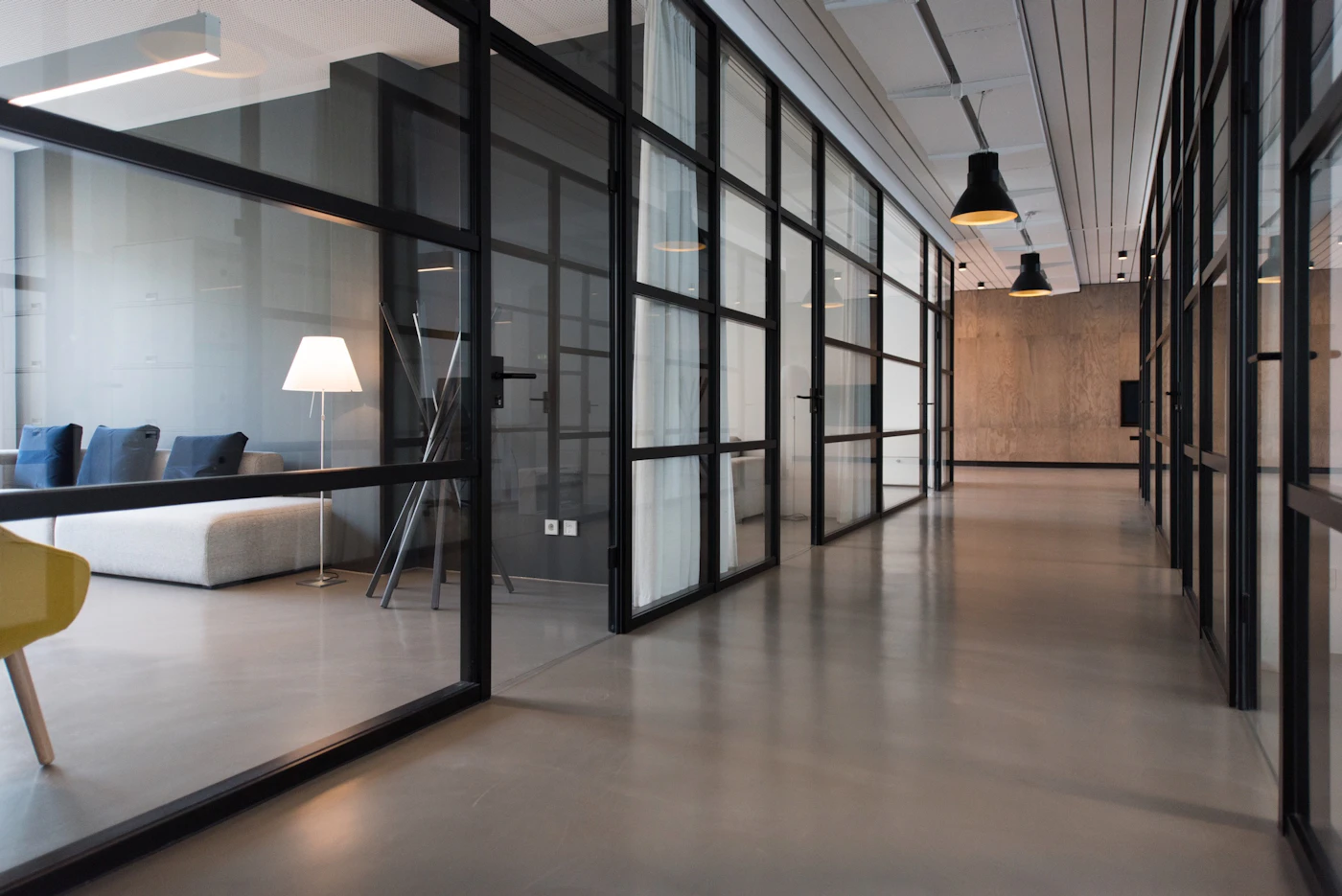 Glass-walled modern office corridor — commercial interior design